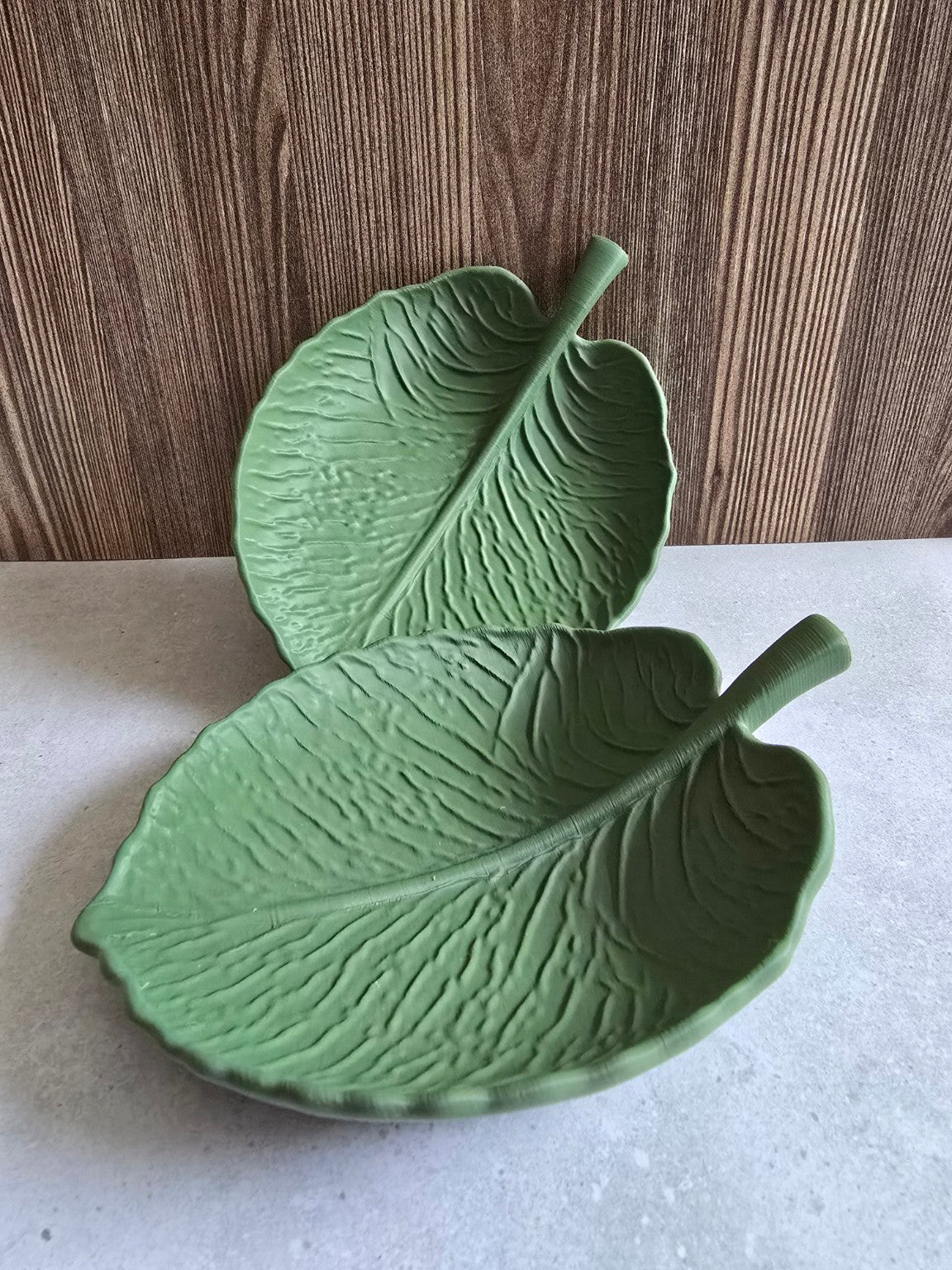 Two olive green Leaf Essence Trays displayed together