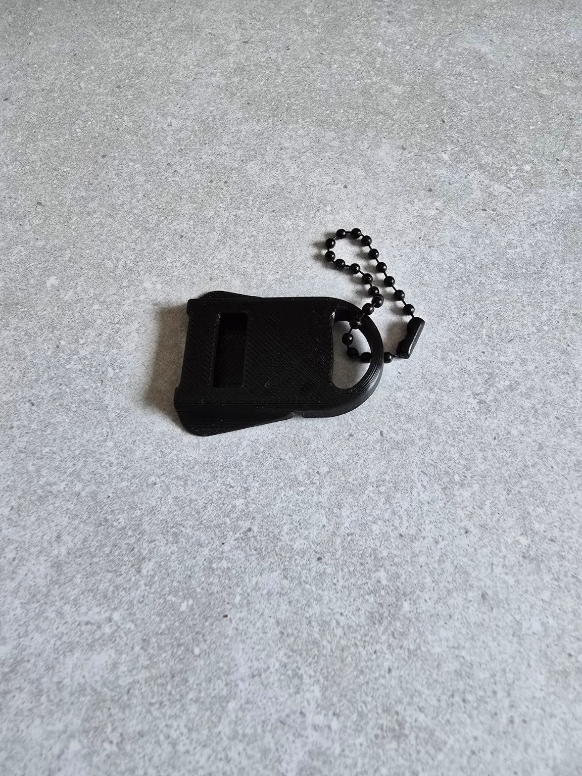 Black can tab opener keychain side view