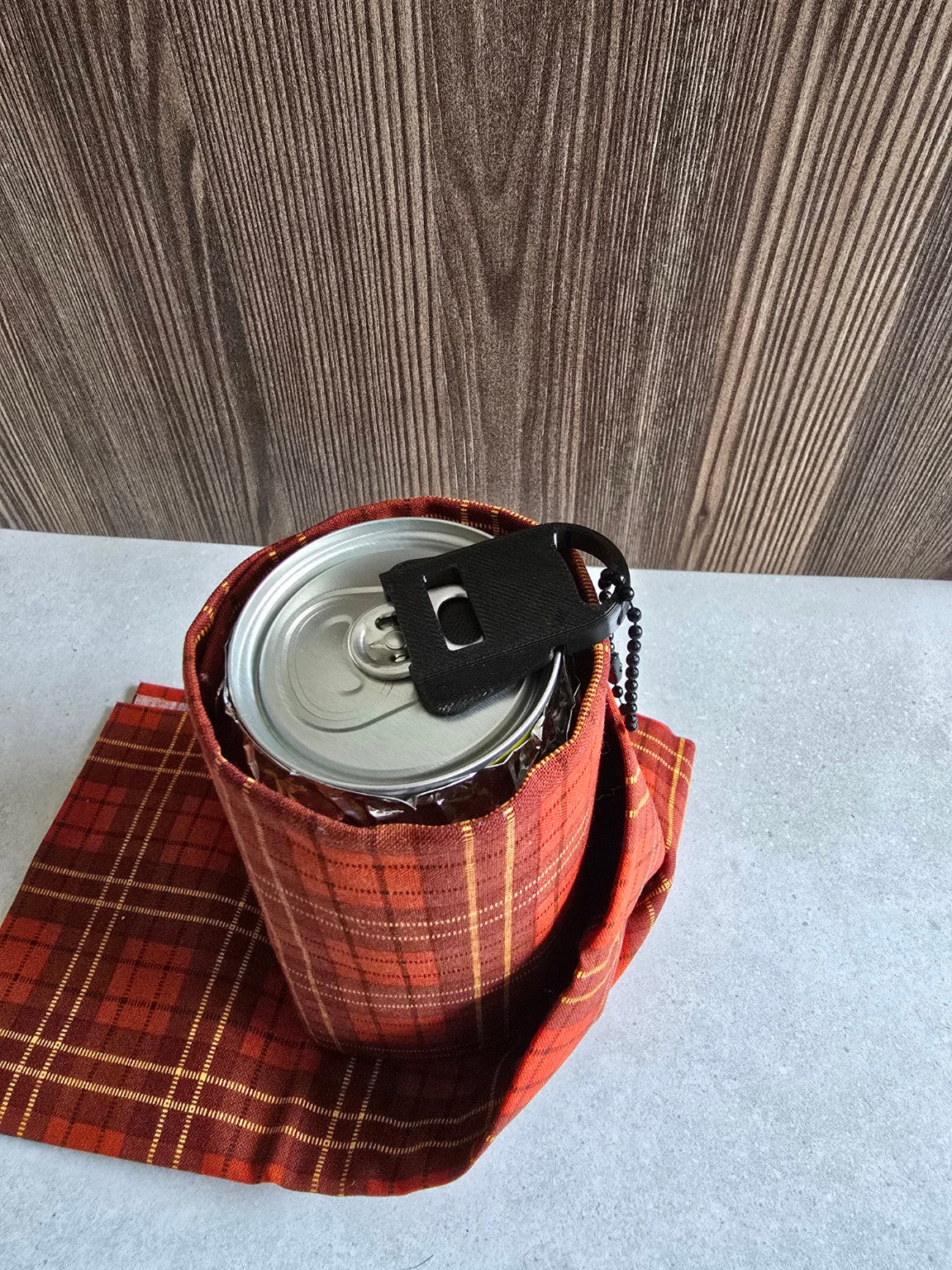 Can tab opener resting on a beverage can