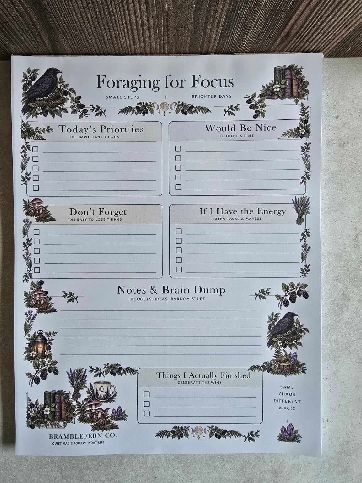 Front view of Foraging for Focus woodland daily planner notepad featuring ravens, mushrooms, priority checklists and notes