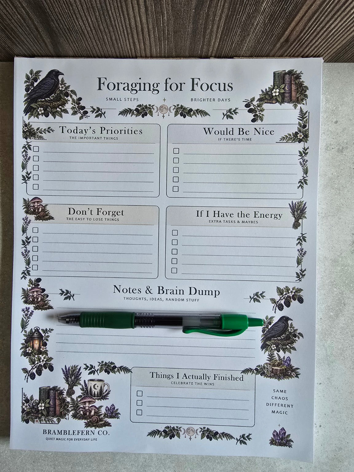Foraging for Focus full-size daily organizer notepad with green pen to show scale