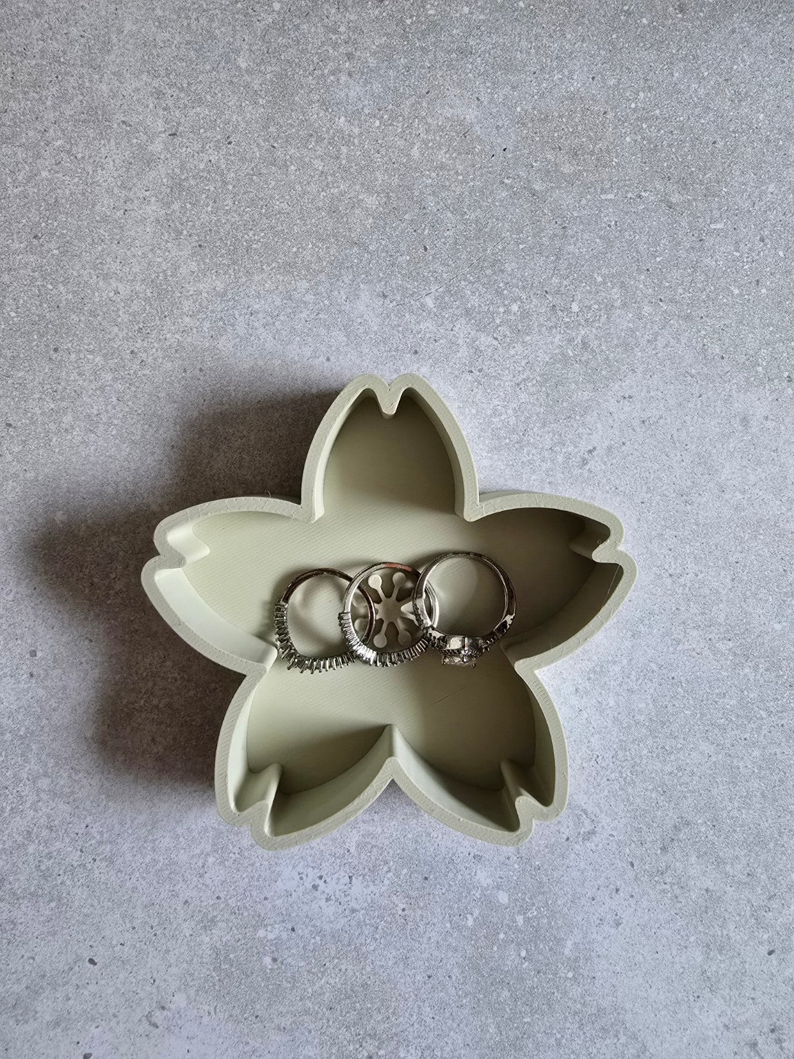 Khaki cherry blossom trinket dish holding rings.