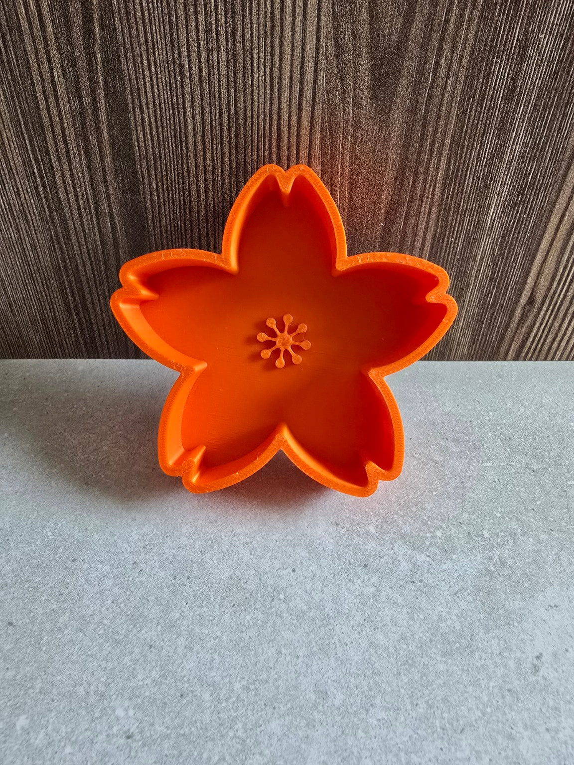 Orange cherry blossom jewelry dish showing its flower shape.