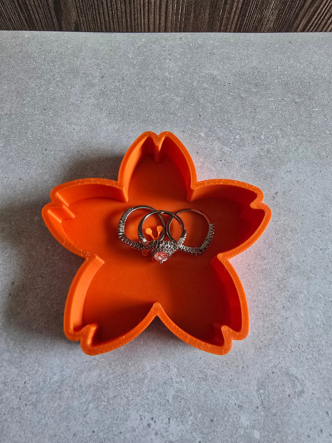 Orange cherry blossom trinket dish holding rings.