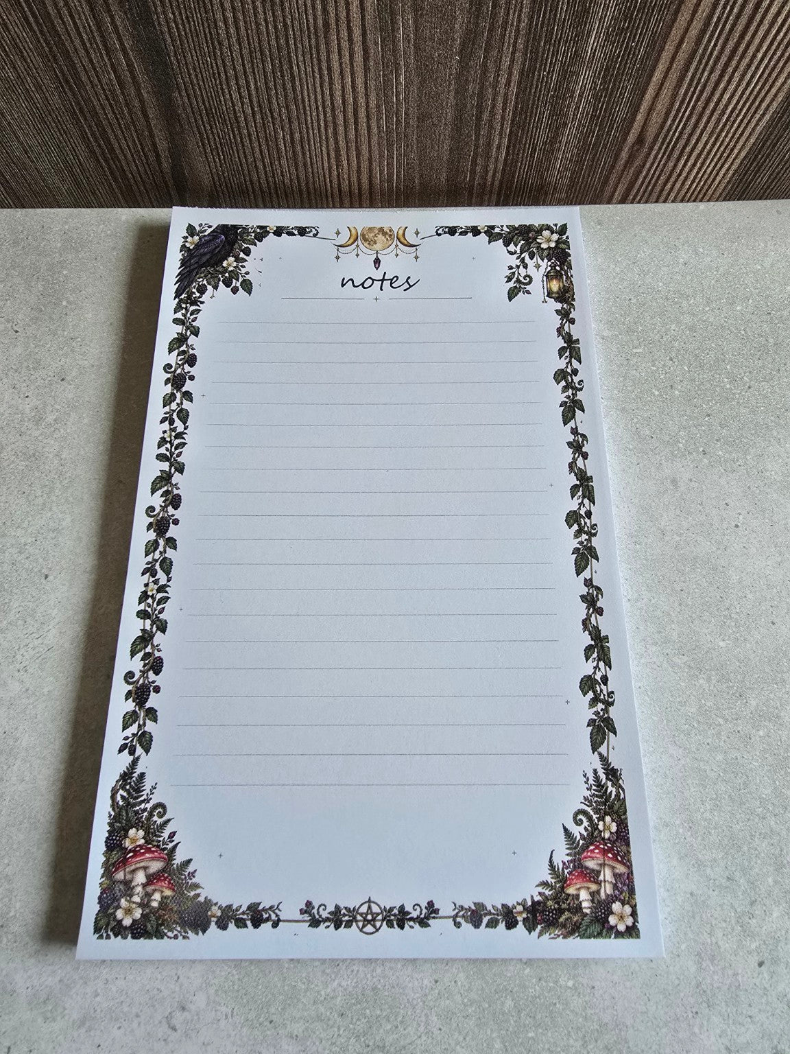 Angled photo of Bramblefern Moonlit Woodland Notes notepad with gothic botanical border