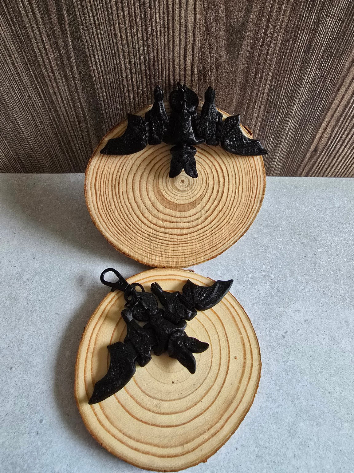 Flexible articulated bat keychain on wooden slices