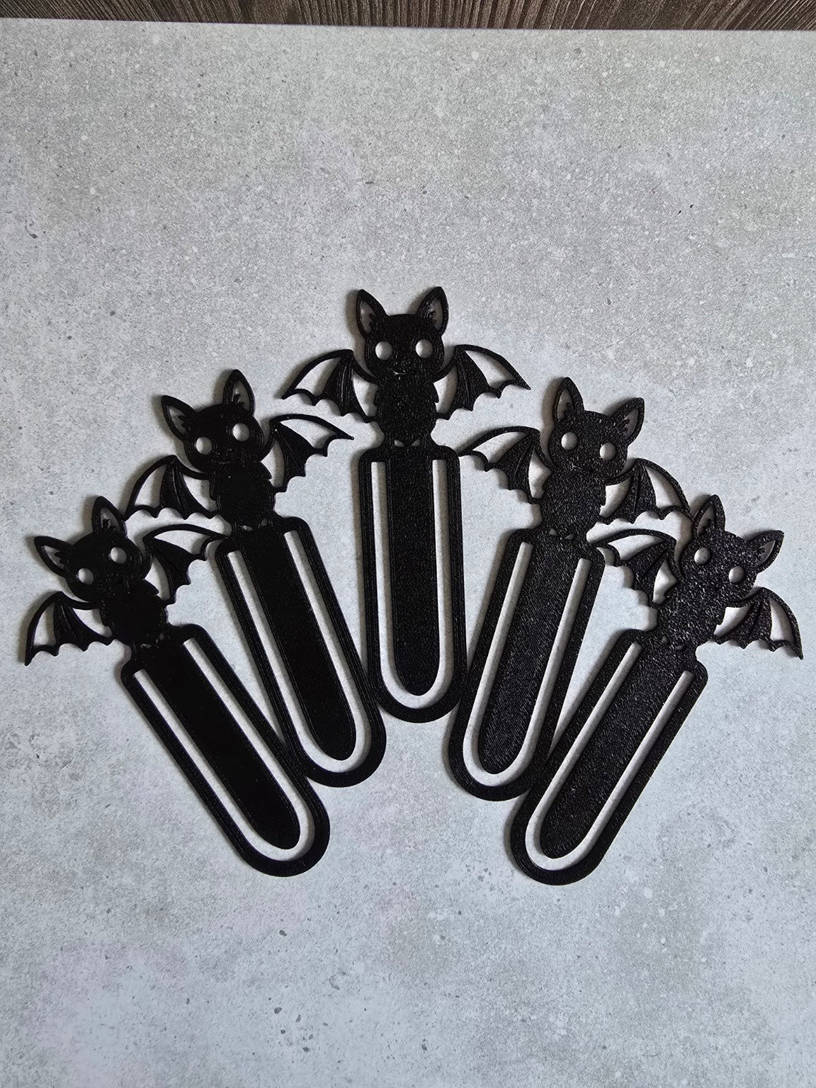 Five black bat bookmarks displayed together
