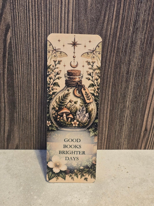 Good Books Brighter Days laminated bookmark featuring a woodland terrarium bottle, mushrooms, crystals, moths, and celestial details.